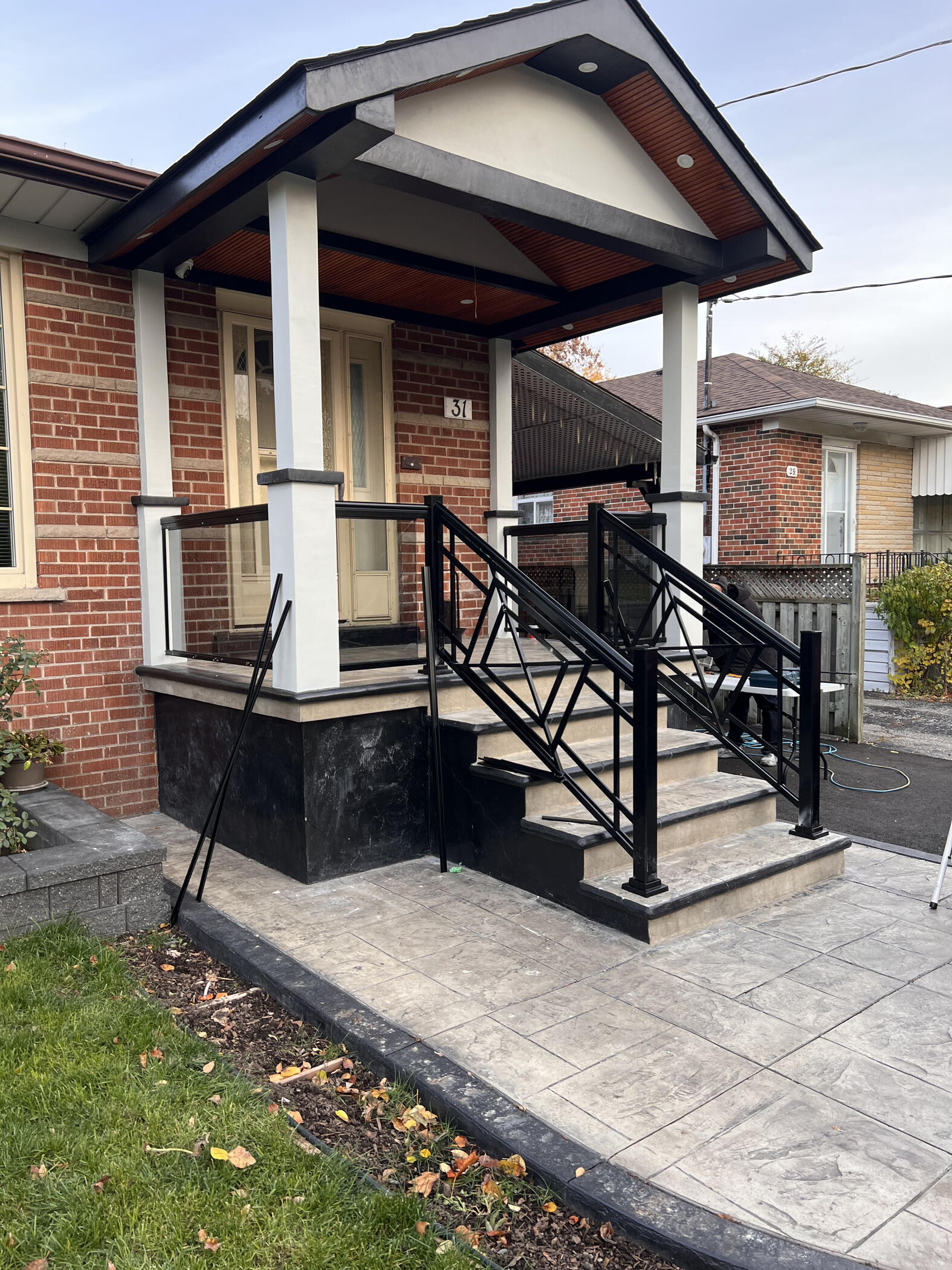 Completed black railing installation on residential exterior stairs
